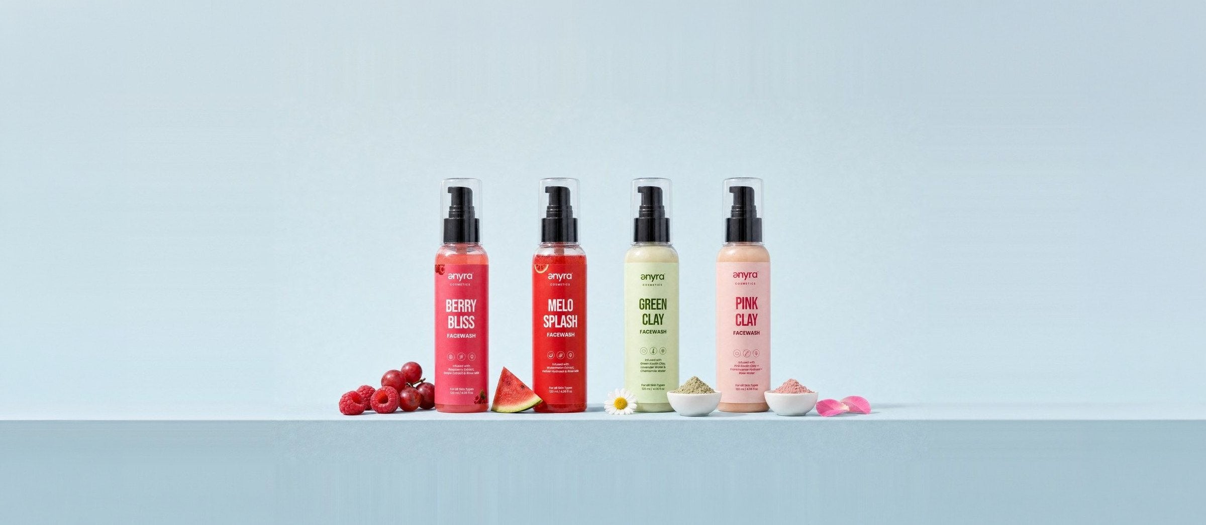 Berry Bliss, Melo Splash, Green Clay and Pink Clay face washes in a row on powder blue with their ingredients